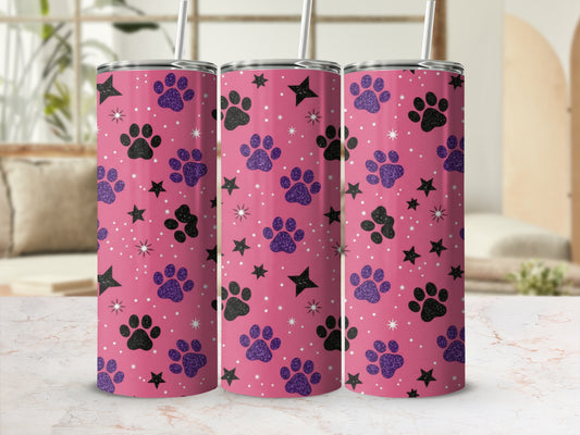 Pink tumbler with black and purple paw prints and stars.