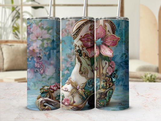 Detailed floral cowboy boot tumbler with straw against a floral background.