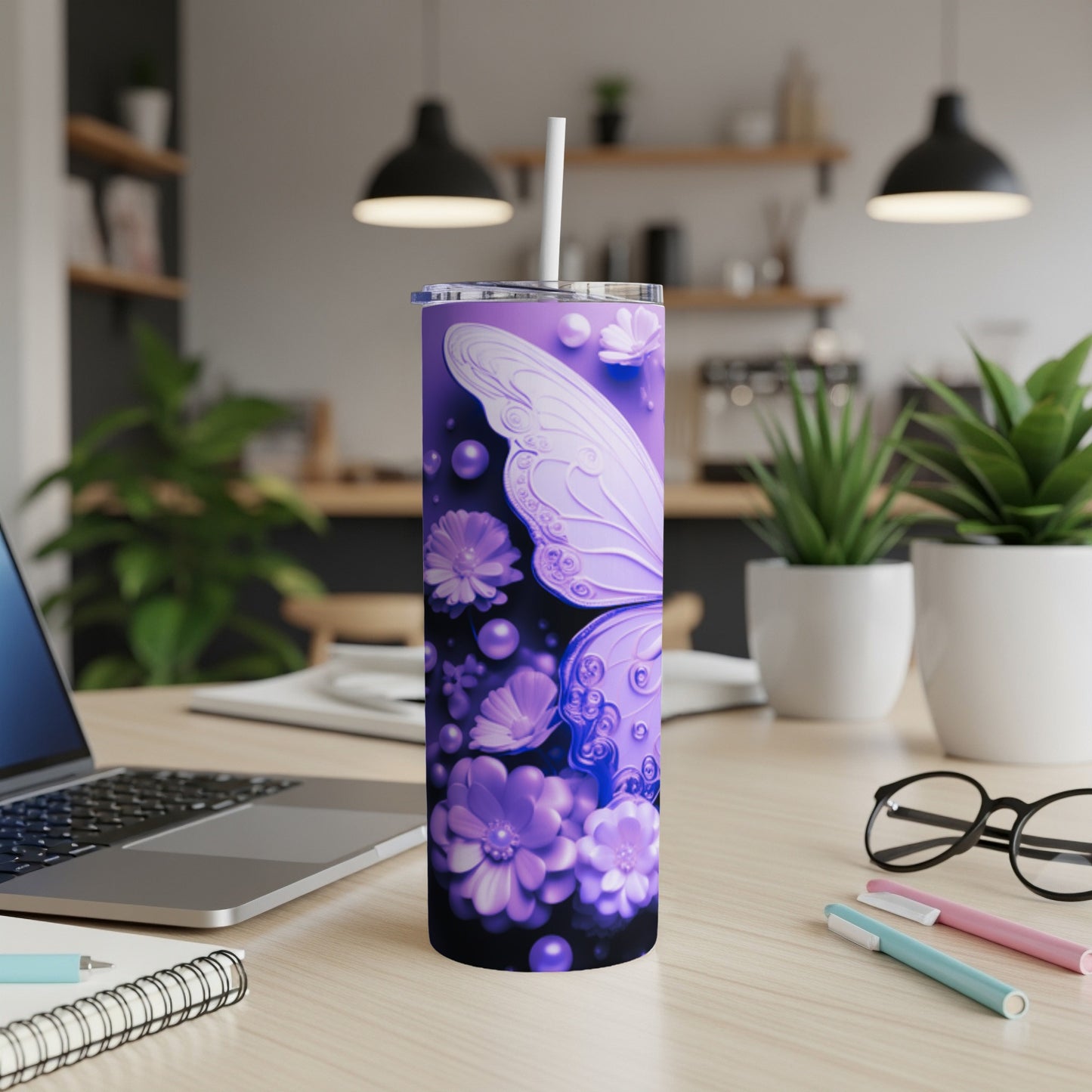 Purple butterfly tumbler with straw on a wooden desk.