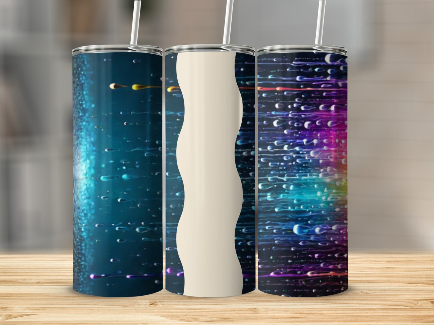 Three tumblers with colorful water splash designs and a wavy cream stripe.