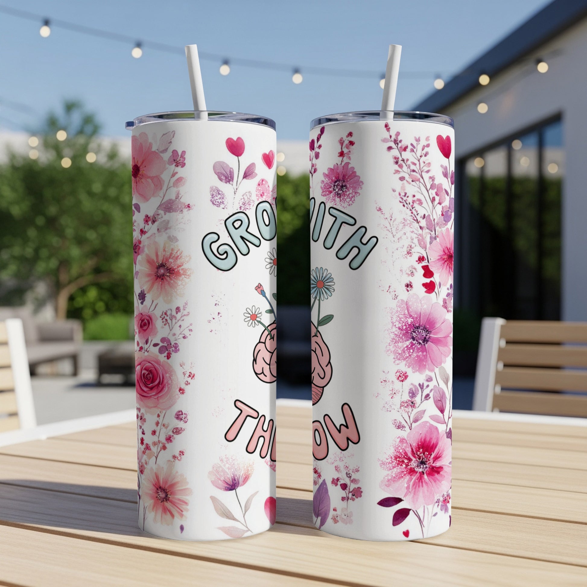 Two tall tumblers with floral and brain motifs, reading "GROWTH THEN GLOW".