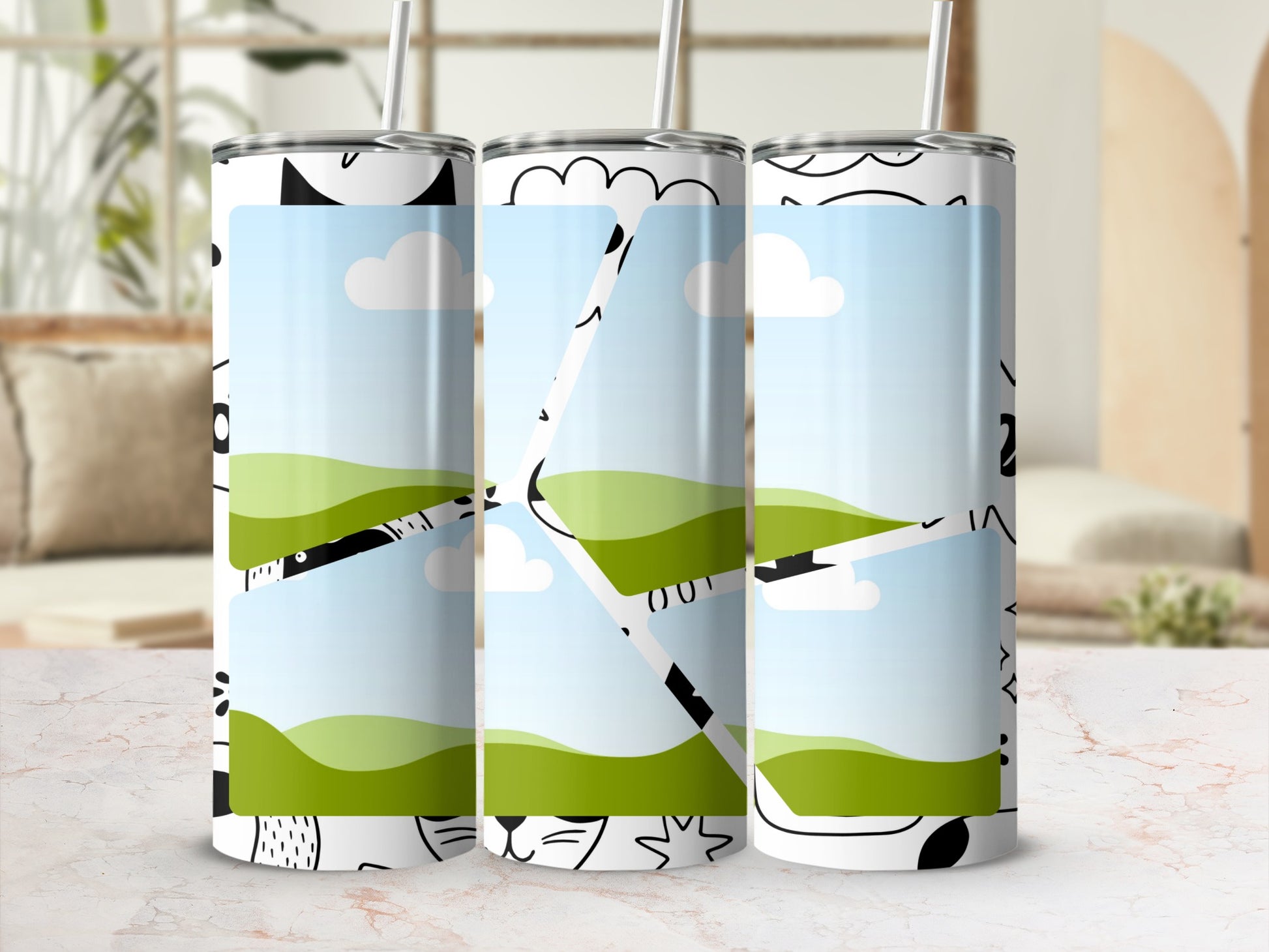Three tumblers with a landscape design and cartoon black and white animal faces.