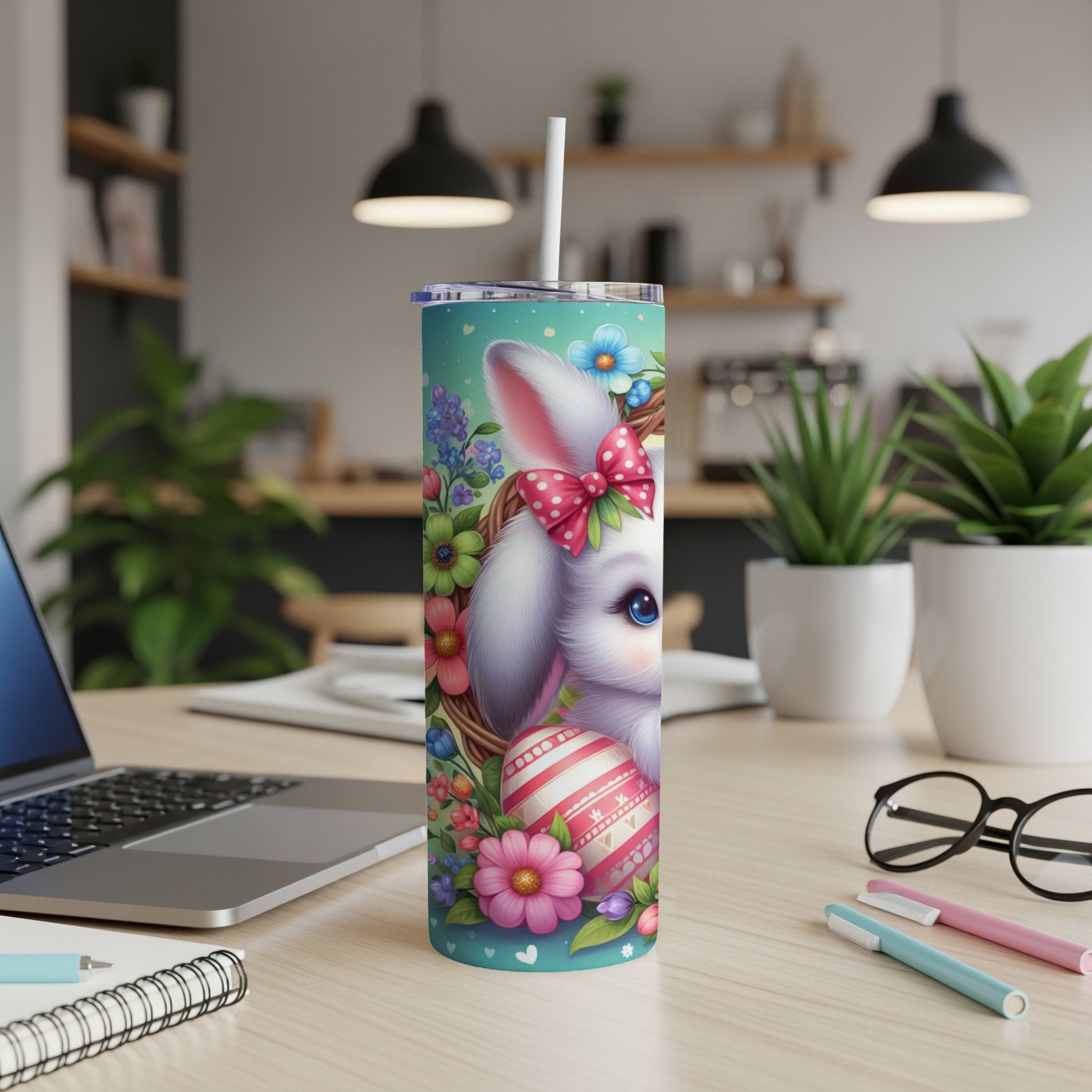 Easter bunny design on a white tumbler with a straw, floral accents, and pink bow.
