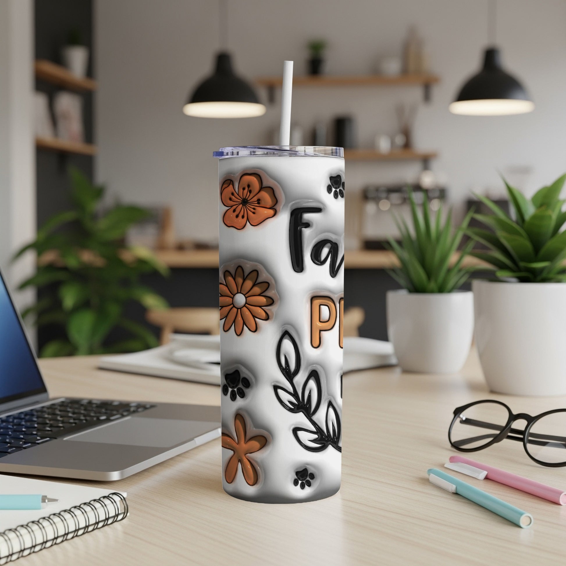 White tumbler with paw prints, flowers, and text "Family Pet" in a home office setting.