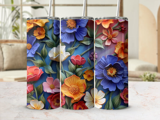 Three tumblers with vibrant, raised floral designs in blue, orange, and pink.