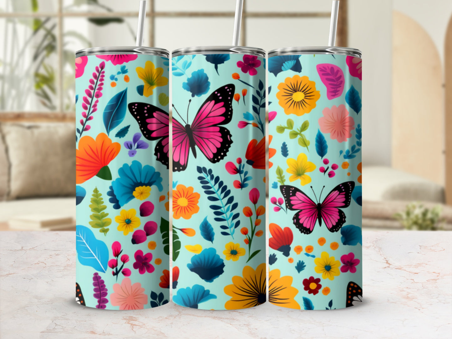 Three tumblers with a light blue background and a vibrant floral and butterfly design.
