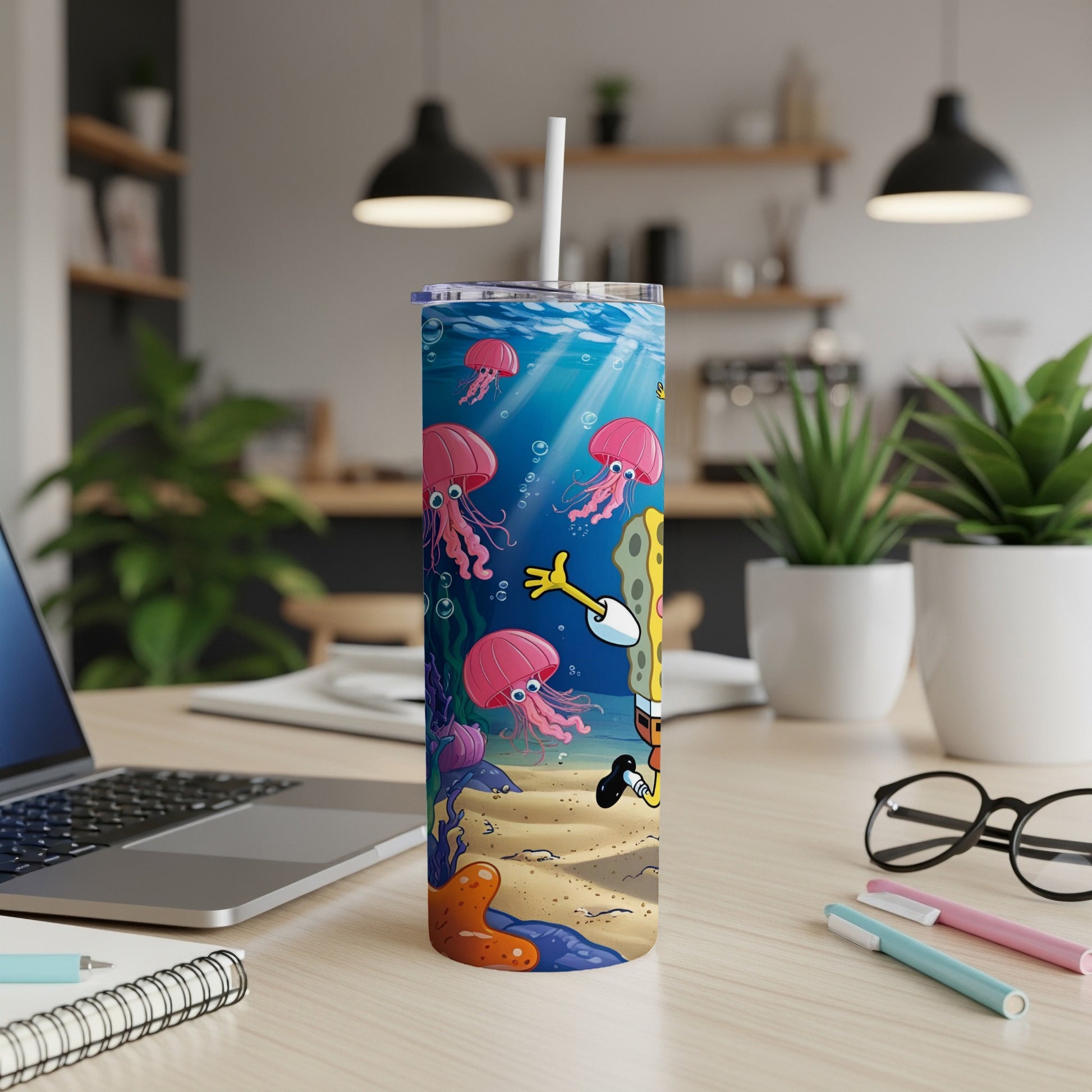 SpongeBob SquarePants tumbler with jellyfish and coral, on a desk.