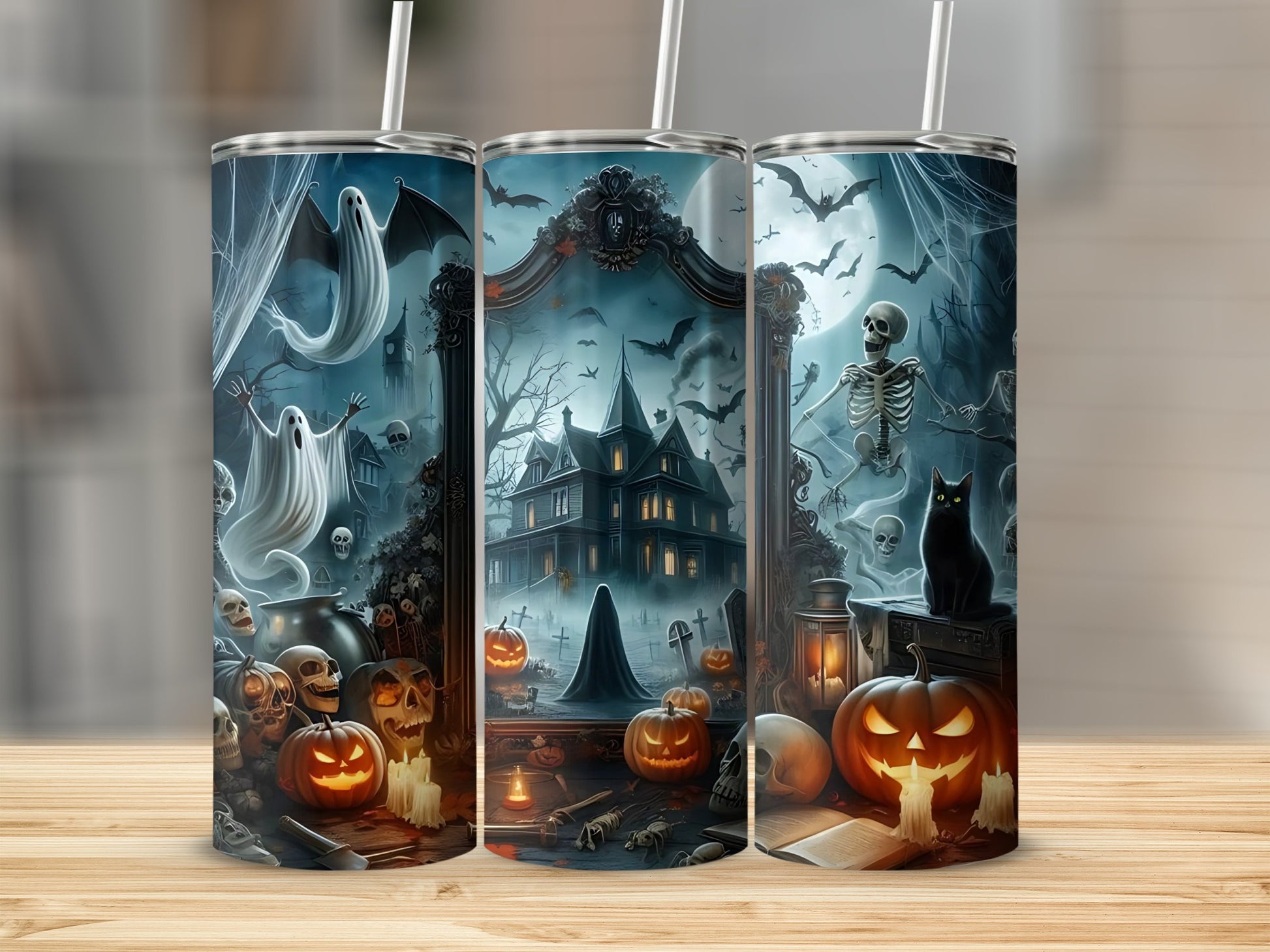 Three tumblers with Halloween scenes featuring ghosts, pumpkins, skeletons, and a haunted house.
