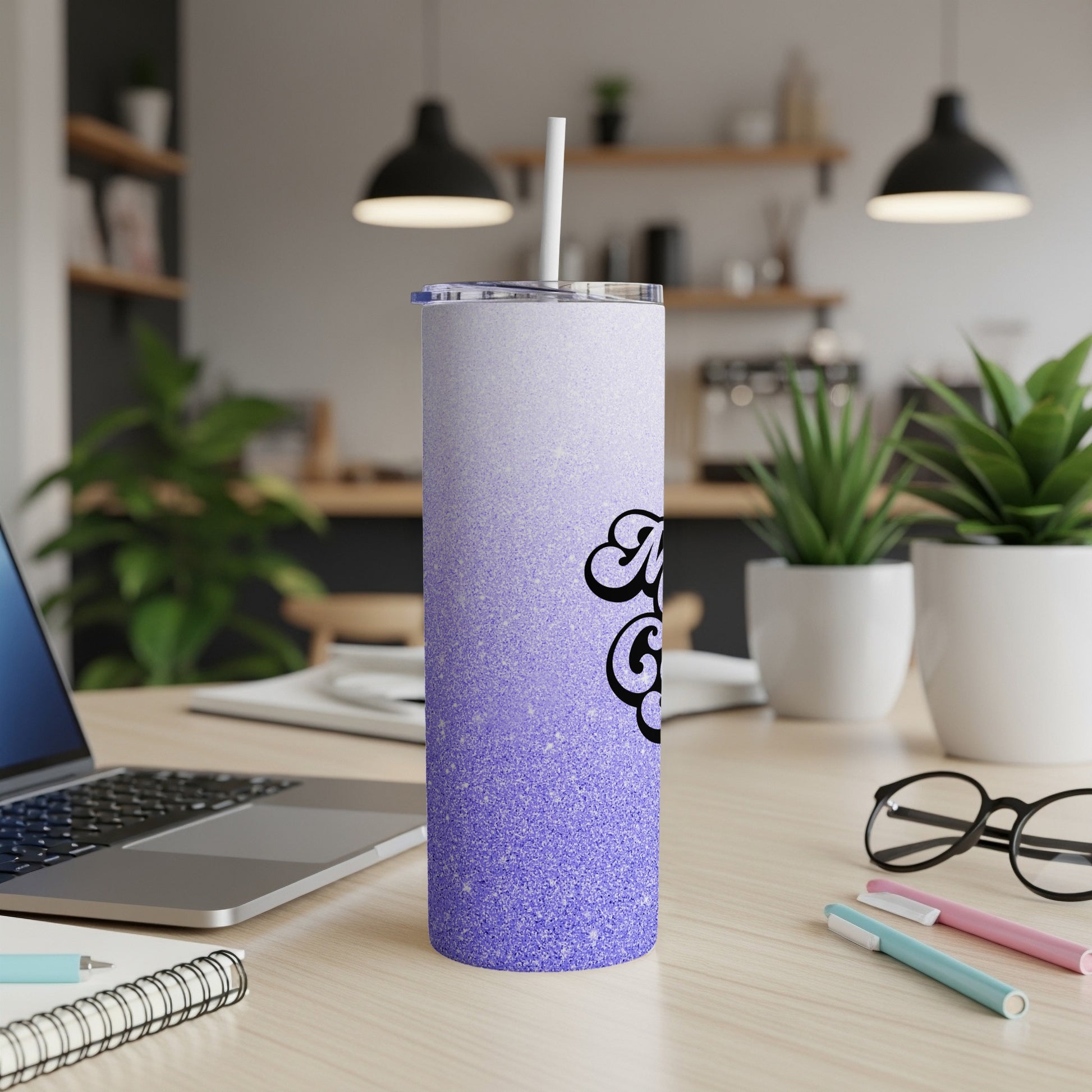 Purple glitter tumbler with "Mama Bear" text on a desk.