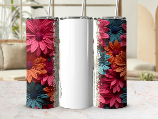 White tumbler with pink, orange, and teal floral pattern and glitter accents.
