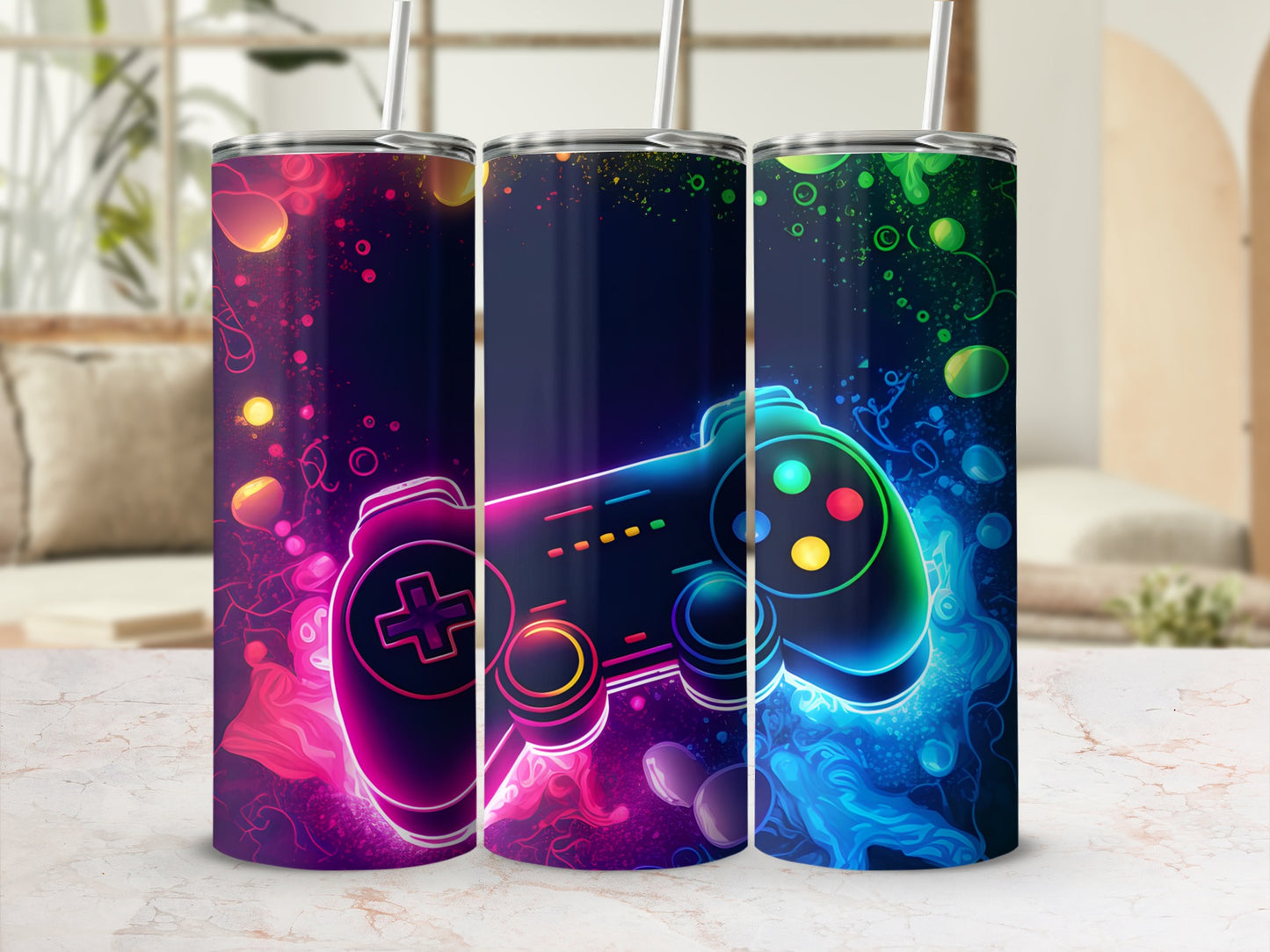Three dark blue tumblers with colorful, glowing video game controllers and abstract accents.