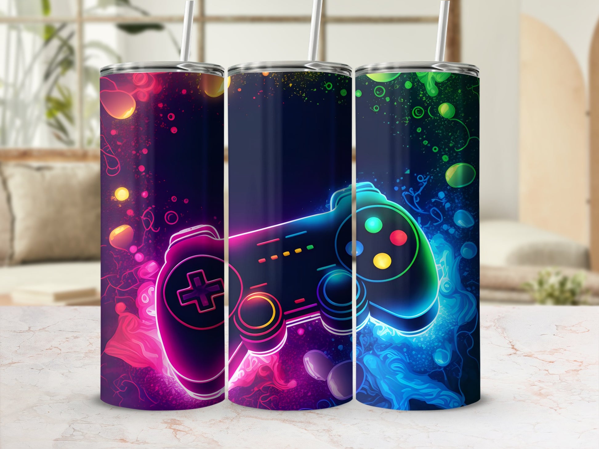 Three dark blue tumblers with colorful, glowing video game controllers and abstract accents.