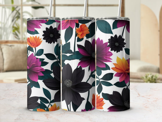 Three tumblers with a dark floral pattern and straws on a marble surface.