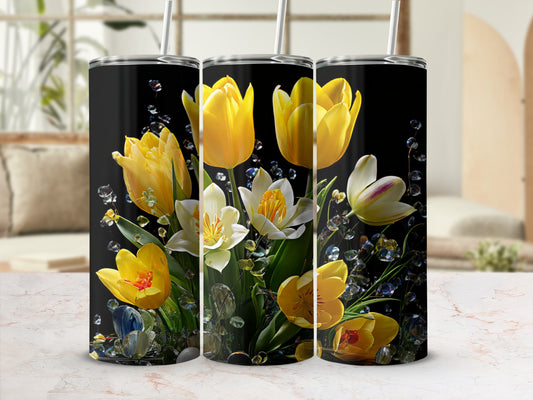 Black tumbler with yellow tulips and white daffodils, surrounded by gems.