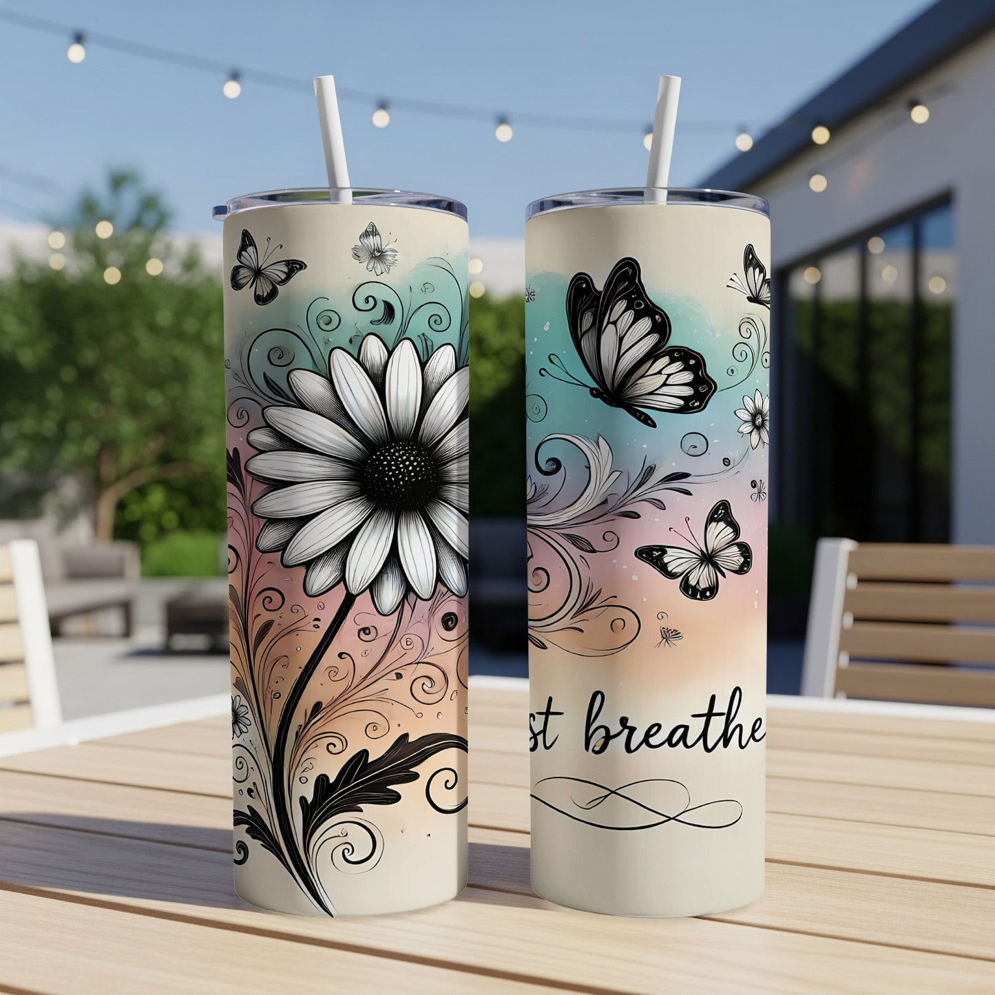 Two tumblers with floral and butterfly designs, one reads "just breathe".