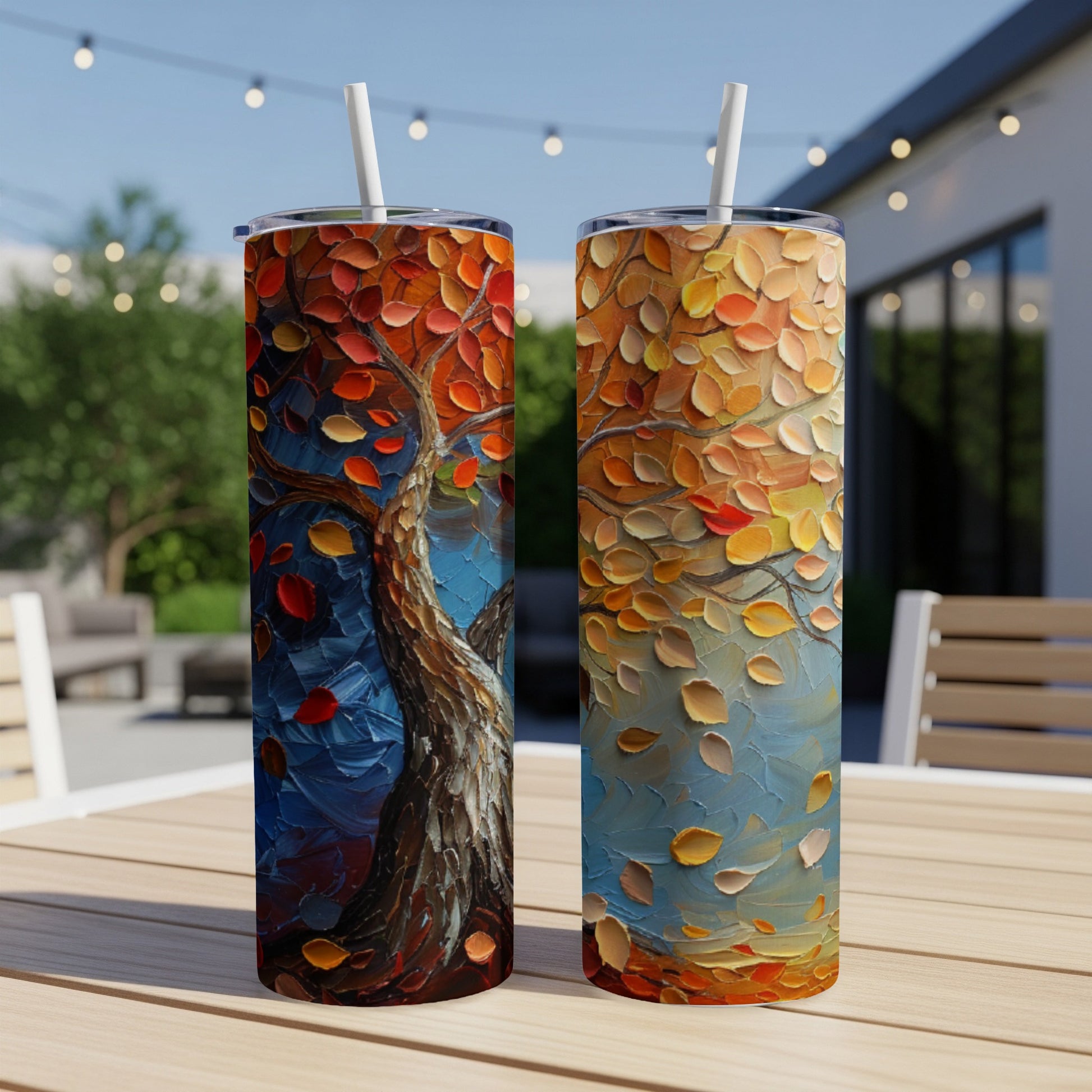 Two tumblers featuring a painterly autumn tree with vibrant orange and red leaves.