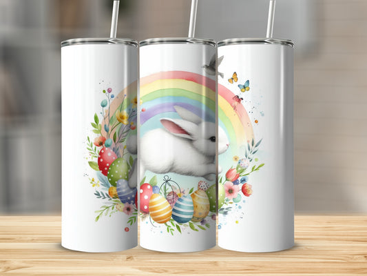 White Easter bunny with rainbow, eggs, and flowers on a tumbler.