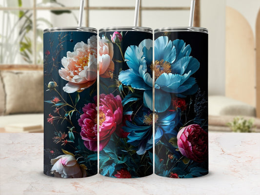 Three tumblers with vibrant blue, pink, and orange floral designs on a dark background.