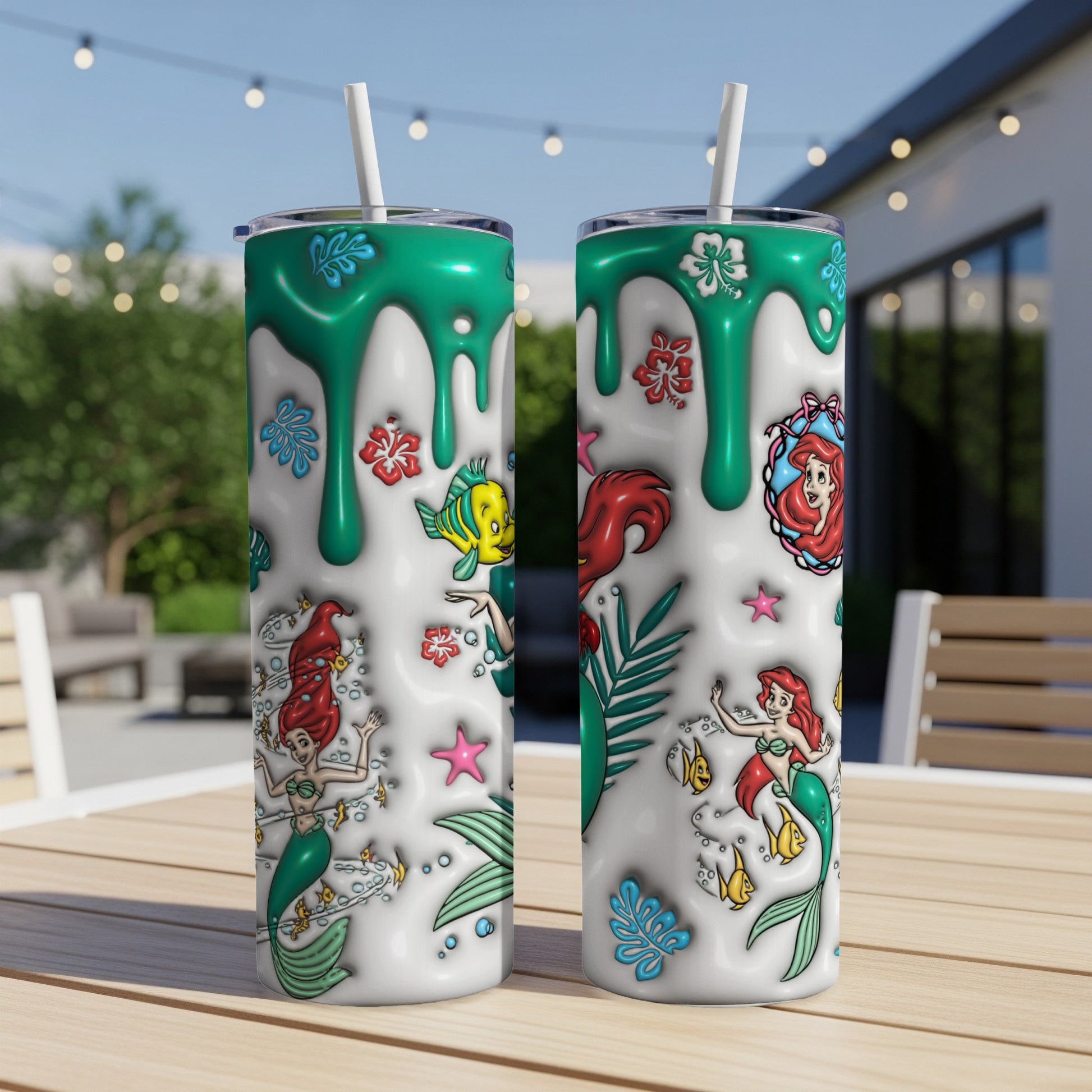 Two tumblers featuring Ariel and Flounder with teal dripping accents.