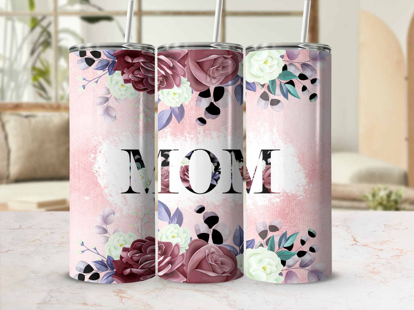 Floral tumbler with "MOM" text on a pink, textured background.