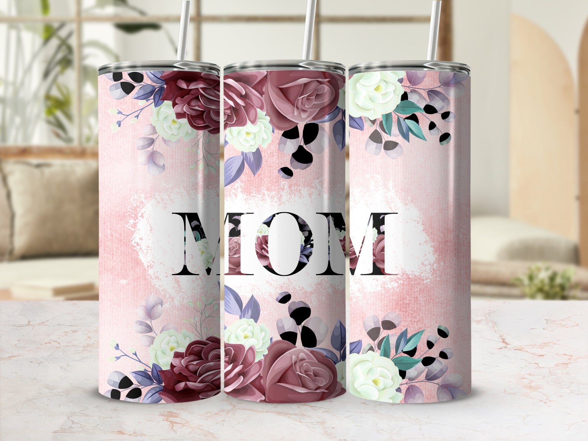Floral tumbler with "MOM" text on a pink, textured background.