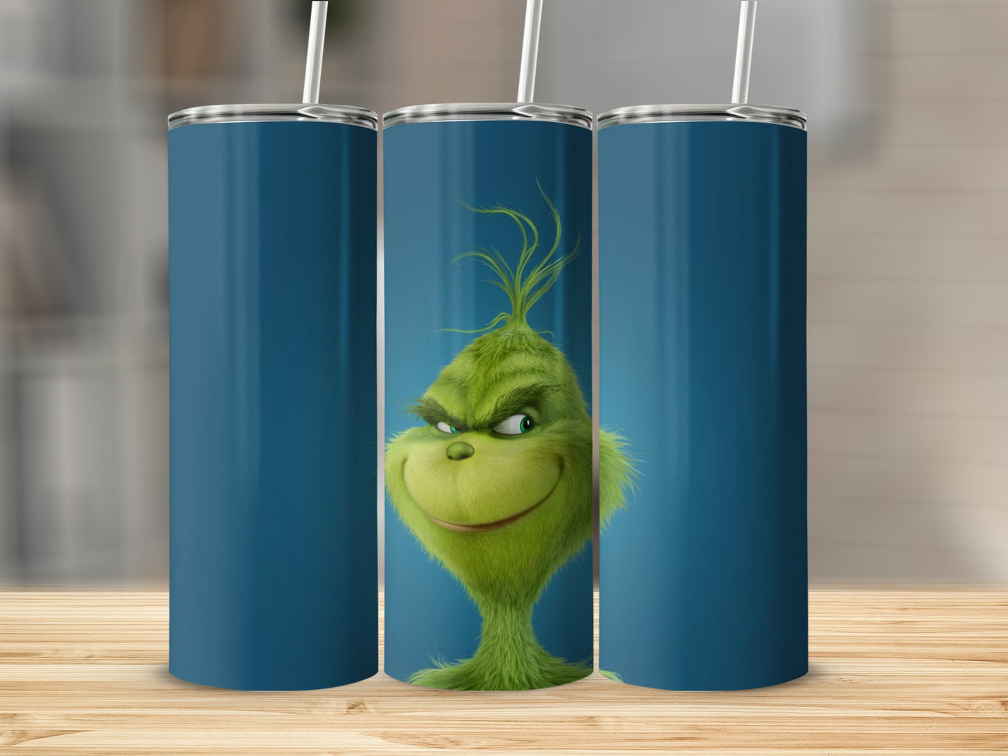 The Grinch's face on three blue-backed tumblers with straws.