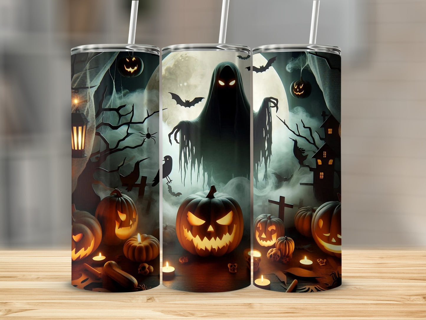 Three tumblers with a spooky Halloween scene featuring a ghost, pumpkins, bats, and a haunted house.