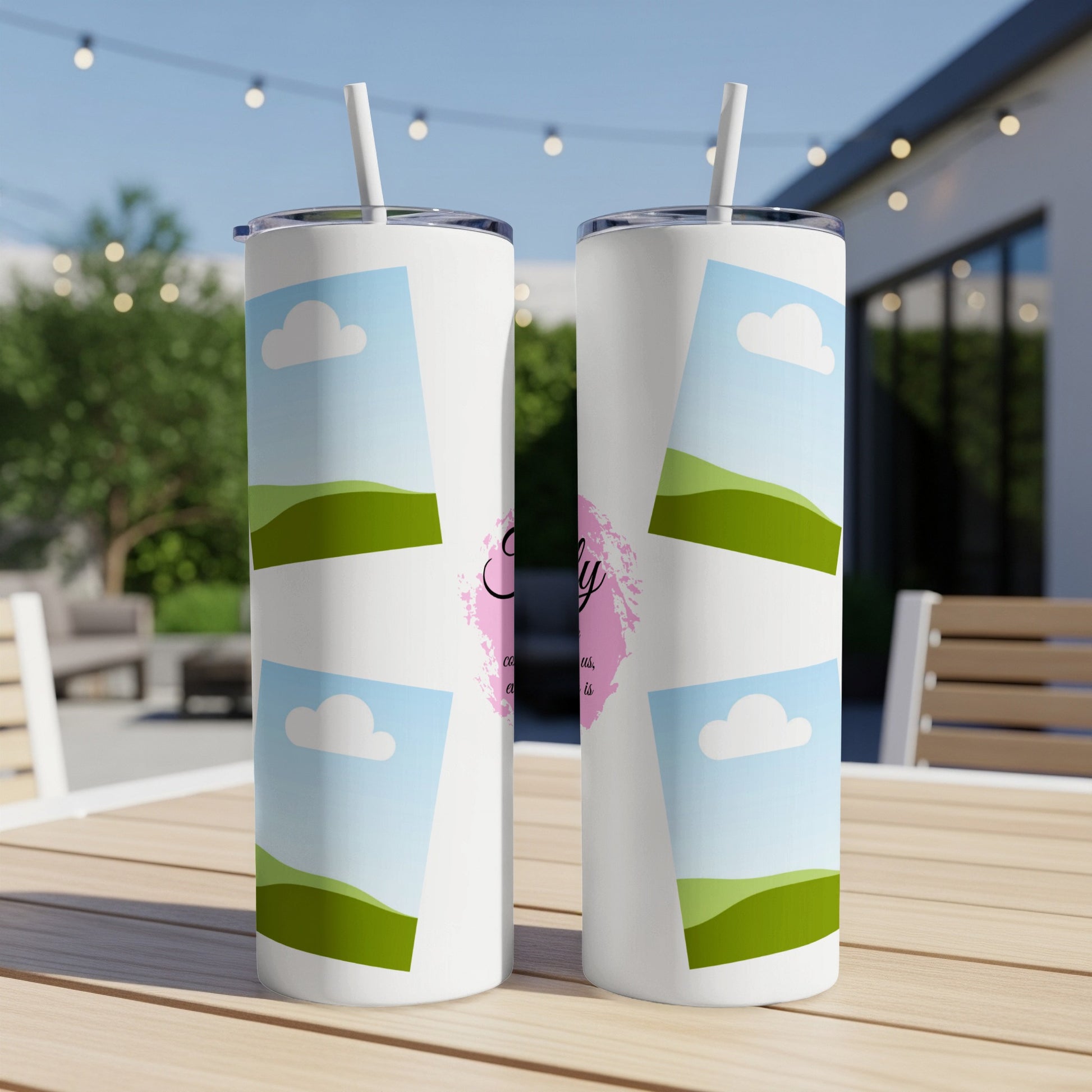 Two white tumblers with a sky and clouds pattern and script text.