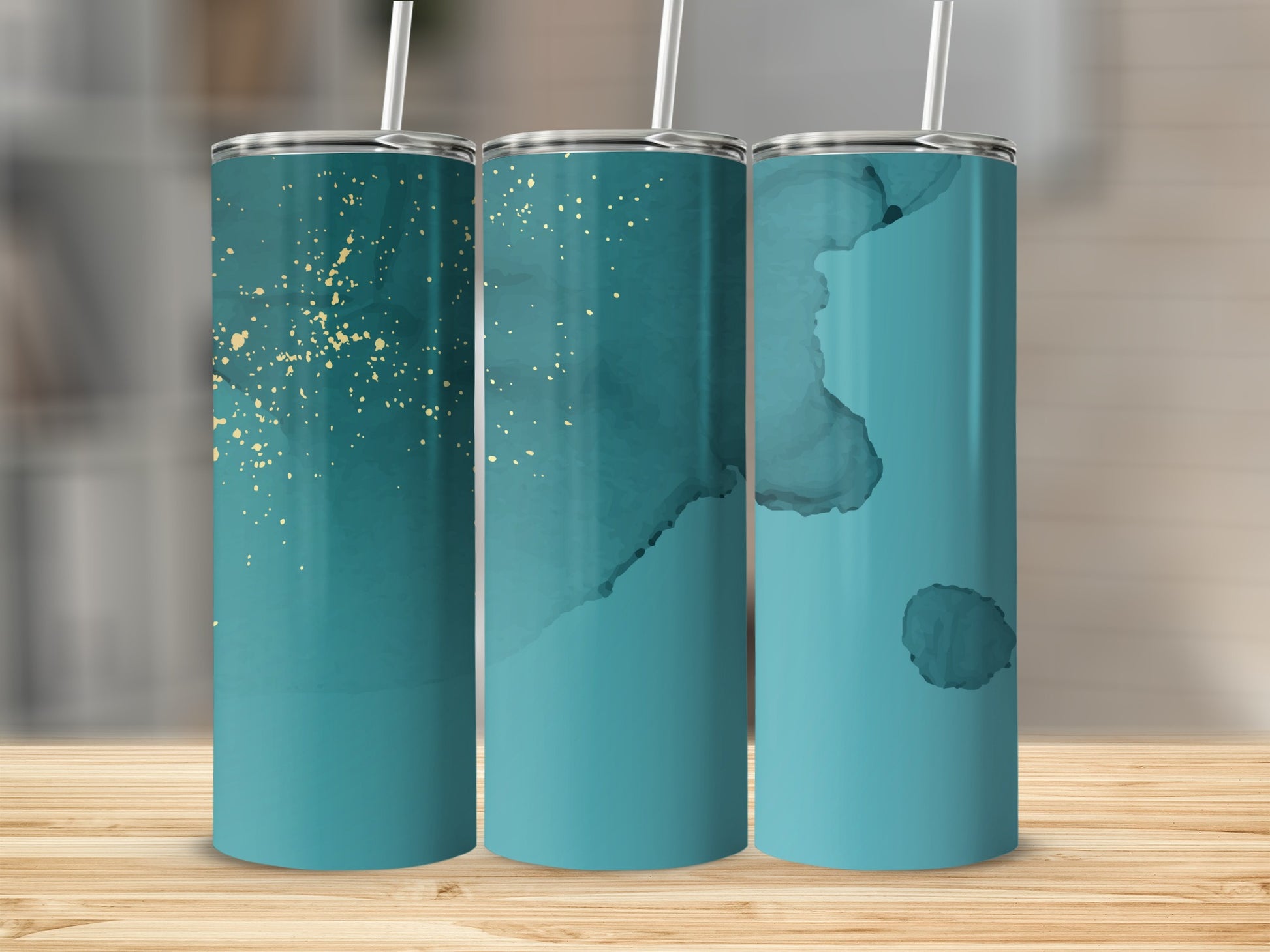 Three teal tumblers with gold speckles and watercolor designs.