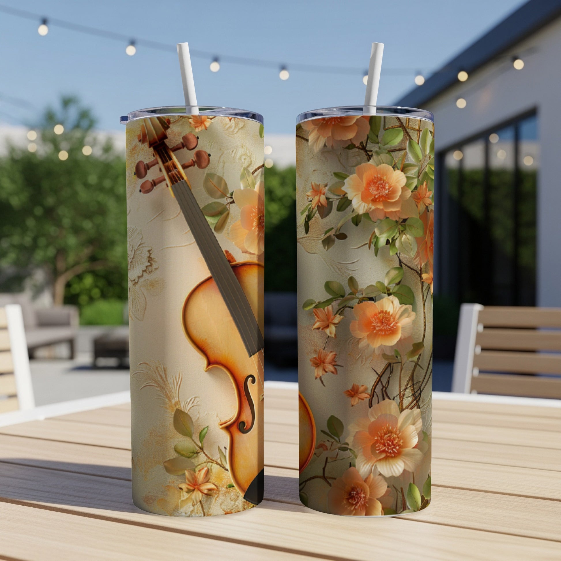 Two tumblers featuring a violin and floral design on a table.