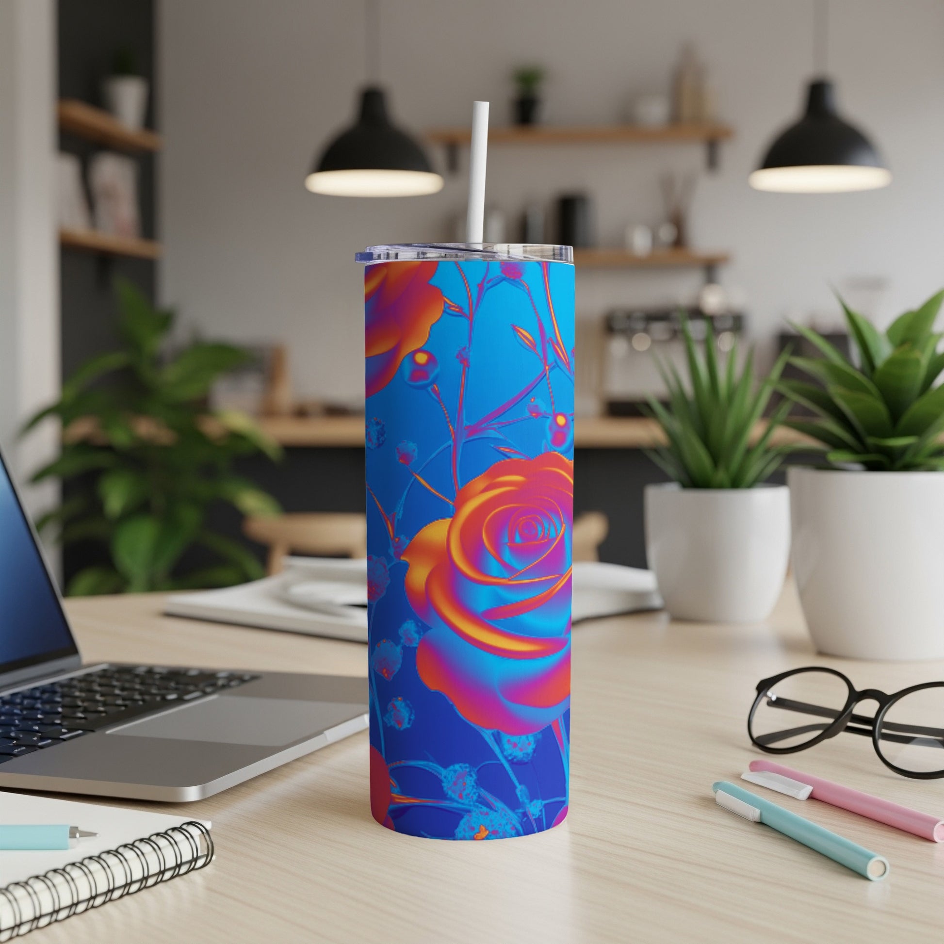 Blue tumbler with vibrant, colorful rose design and white straw.