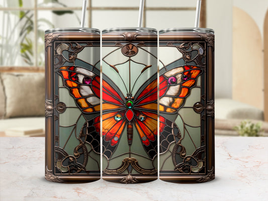 Three stainless steel tumblers with stained glass butterfly design and straws.