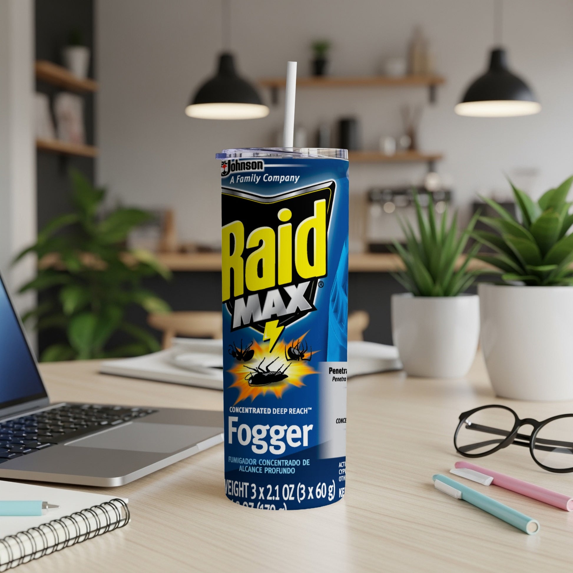 Raid Max Concentrated Fogger can on a desk with a laptop and pens.