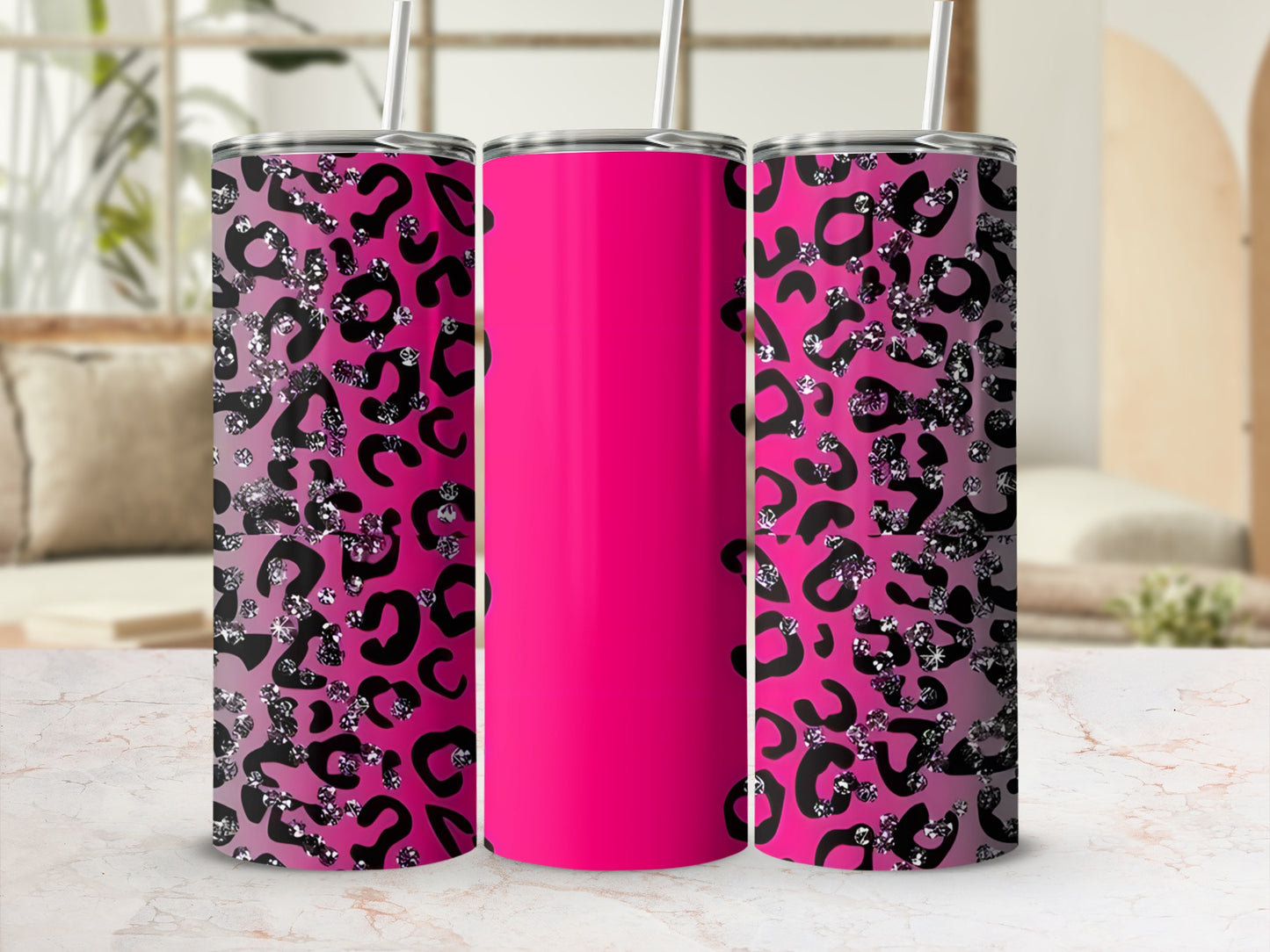 Pink tumbler with black and silver leopard print on a marble countertop.