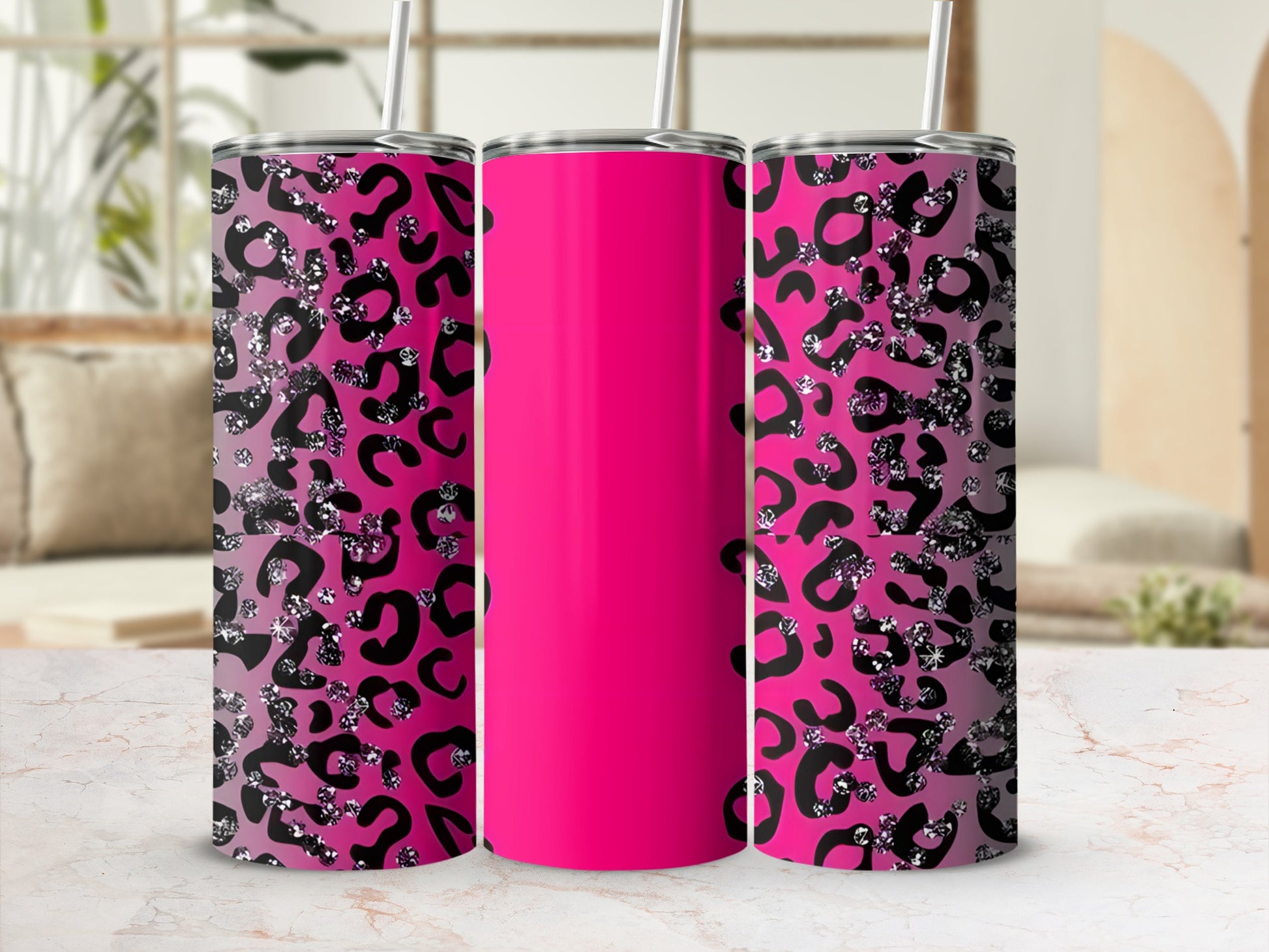 Pink tumbler with black and silver leopard print on a marble countertop.