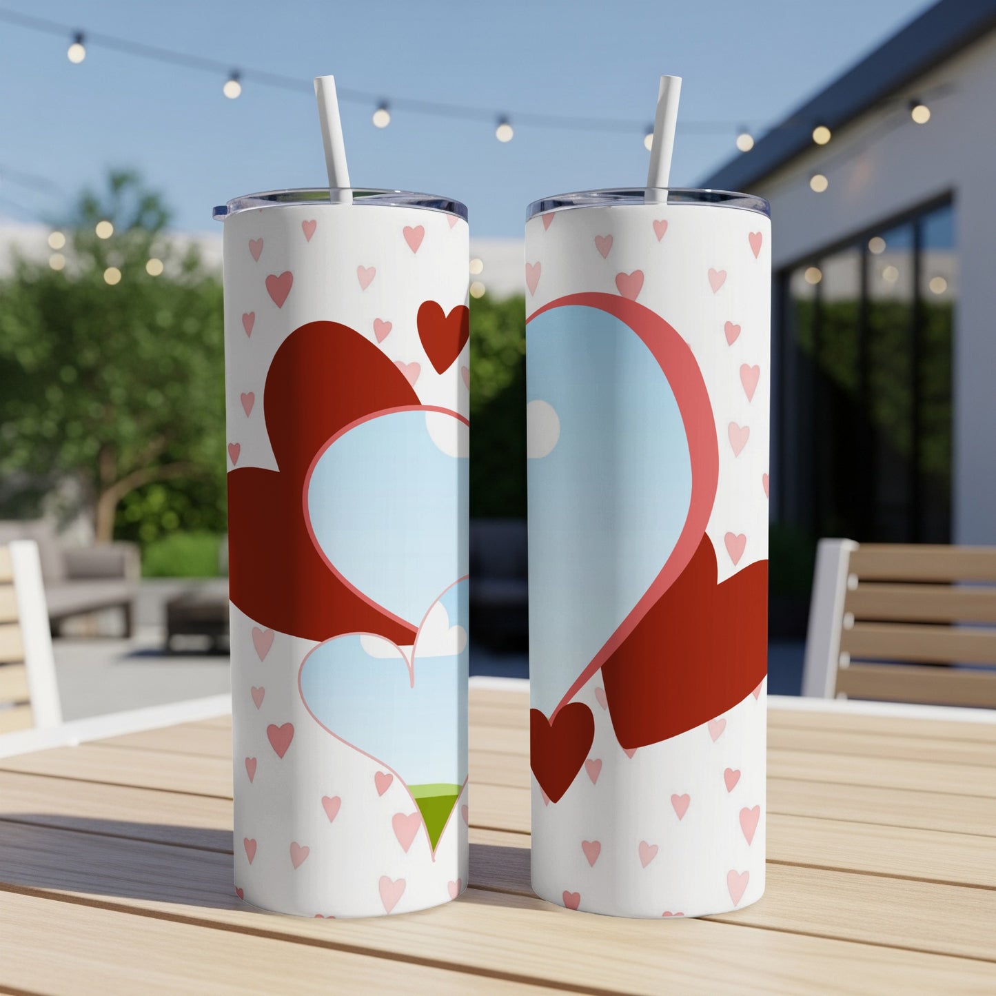 White tumblers with pink hearts and red heart designs, featuring straws.