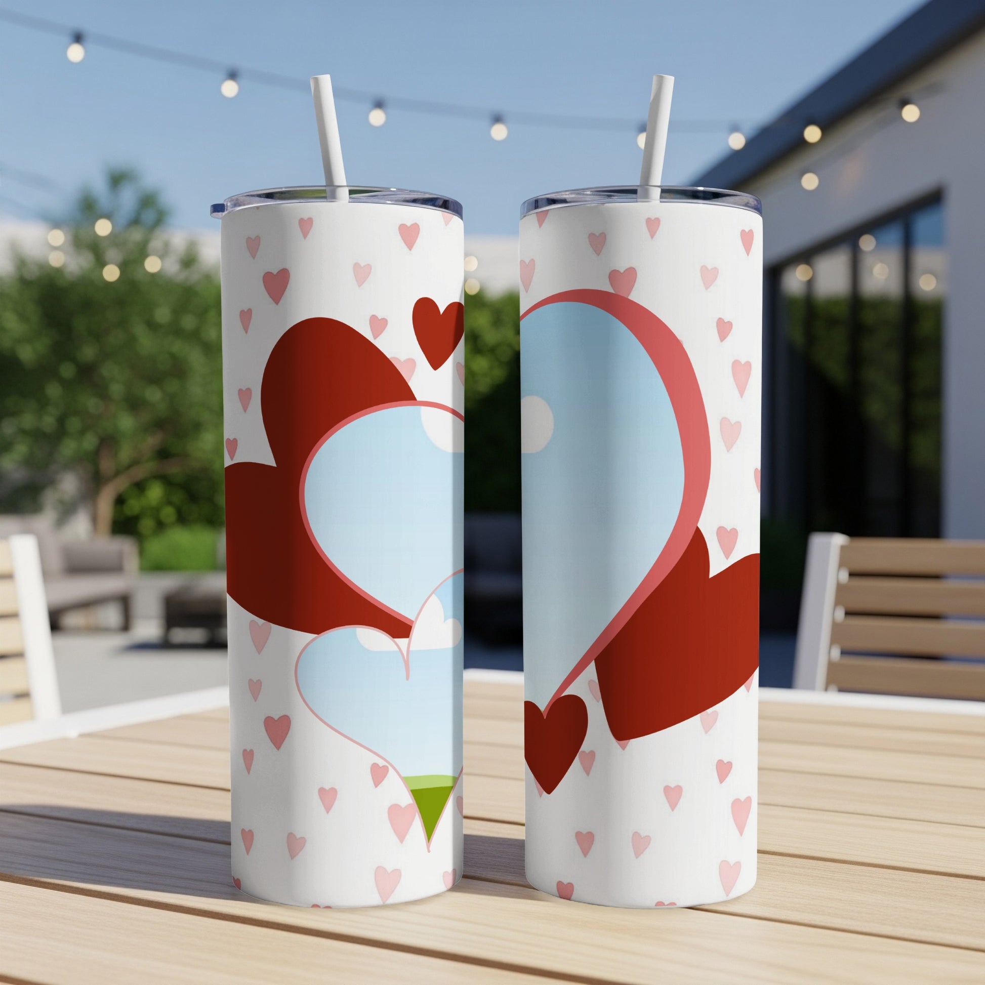 White tumblers with pink hearts and red heart designs, featuring straws.