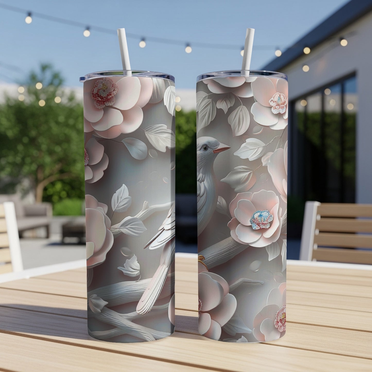 Two tumblers with a floral bird design on a wooden table.