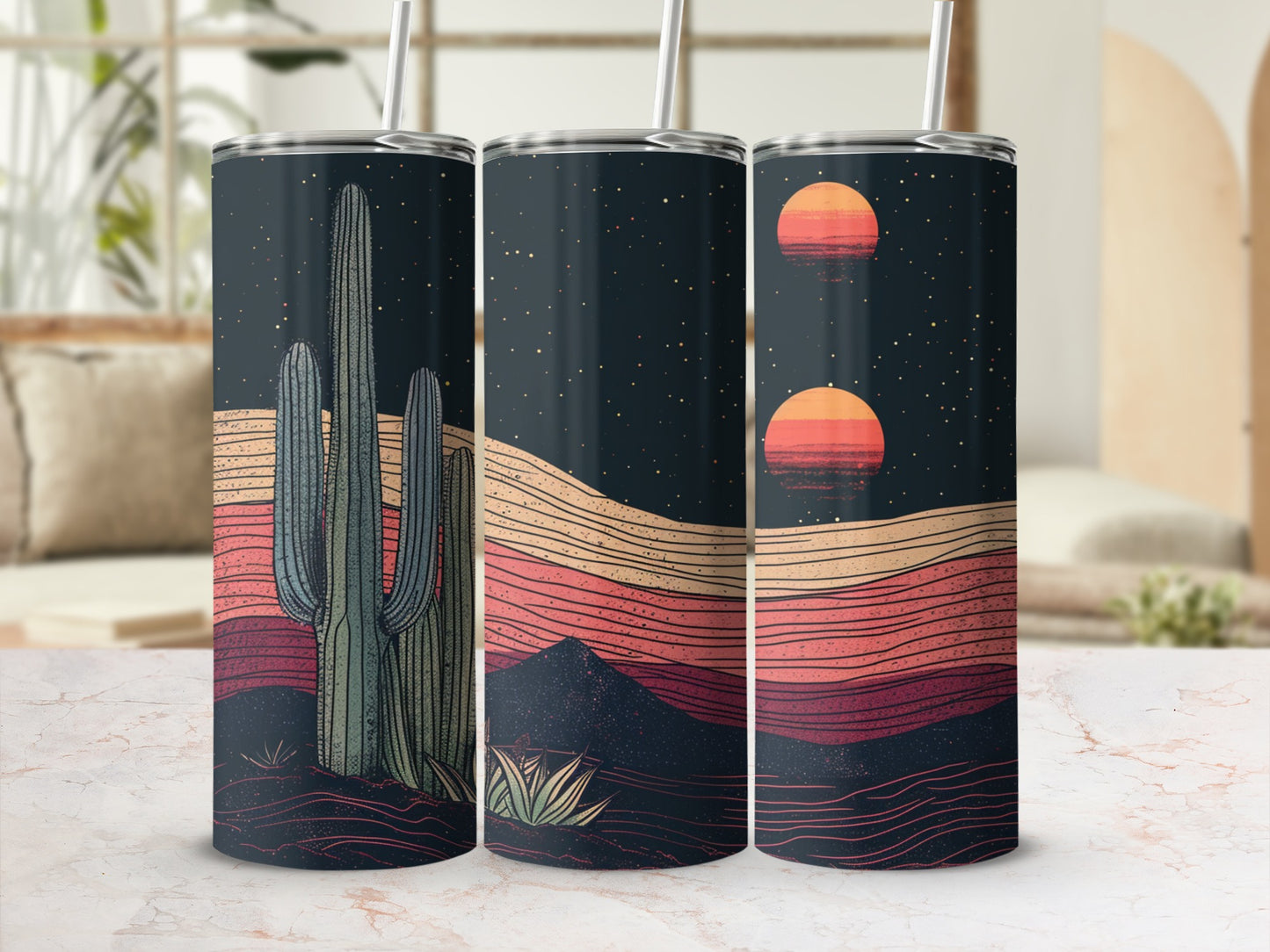 Desert sunset with cactus and mountains depicted on three tumblers.