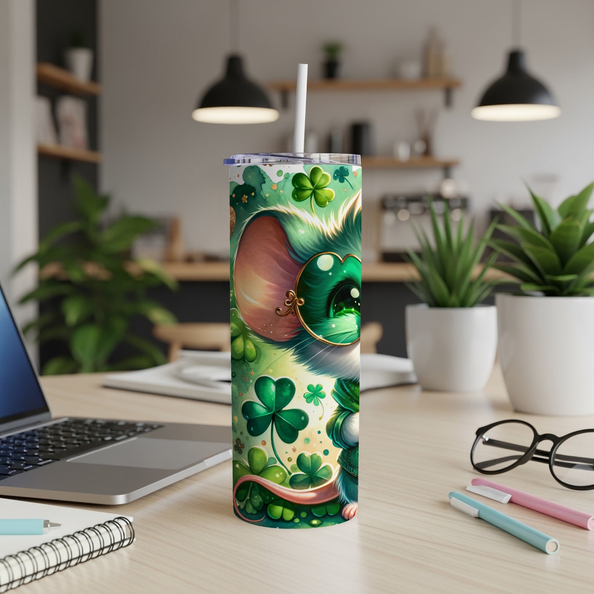 Green cartoon mouse with shamrocks on a tumbler with a straw.