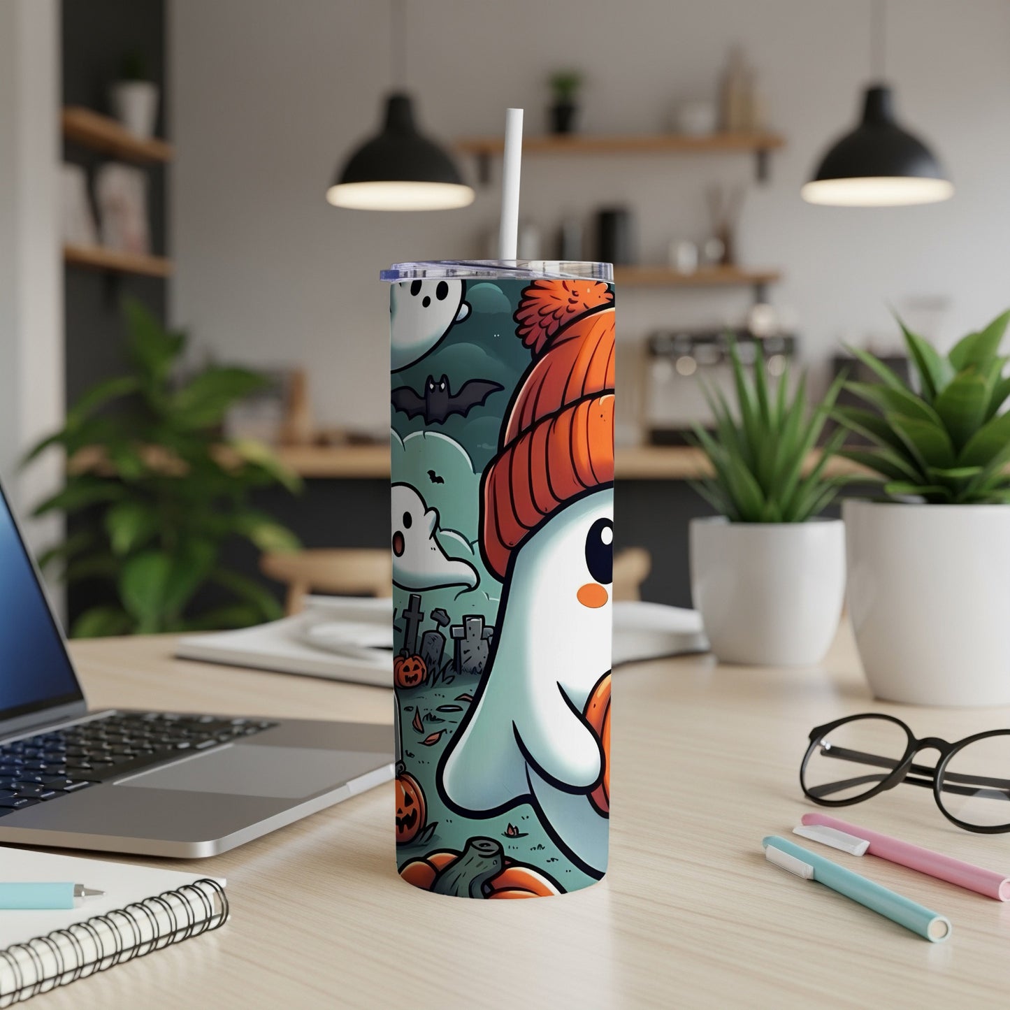 Tumbler featuring a cute ghost in a beanie with bats and pumpkins on a graveyard background.