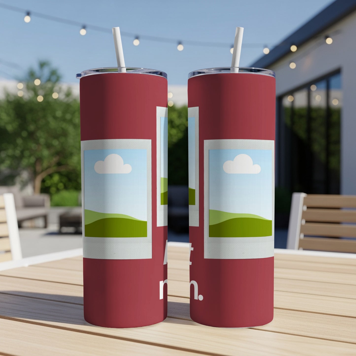 Two red tumblers with a picture of a cloud and grassy hills design.