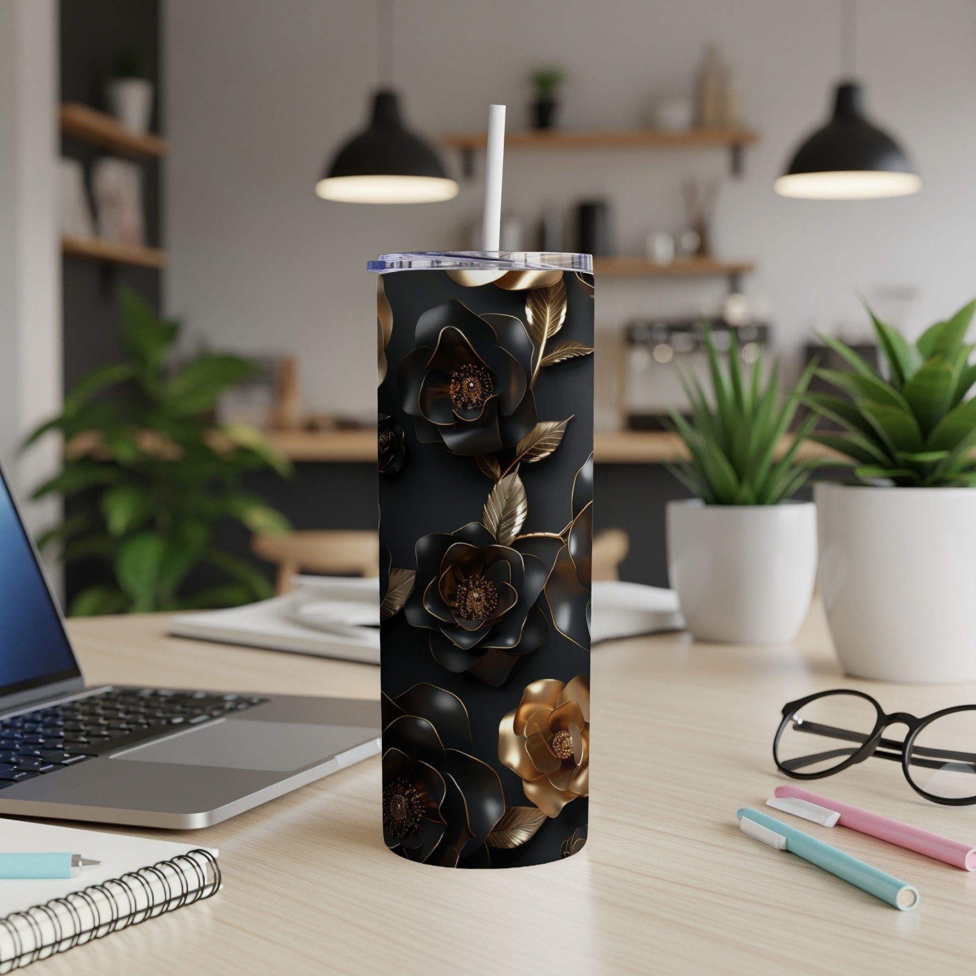 Black tumbler with gold and black floral design.