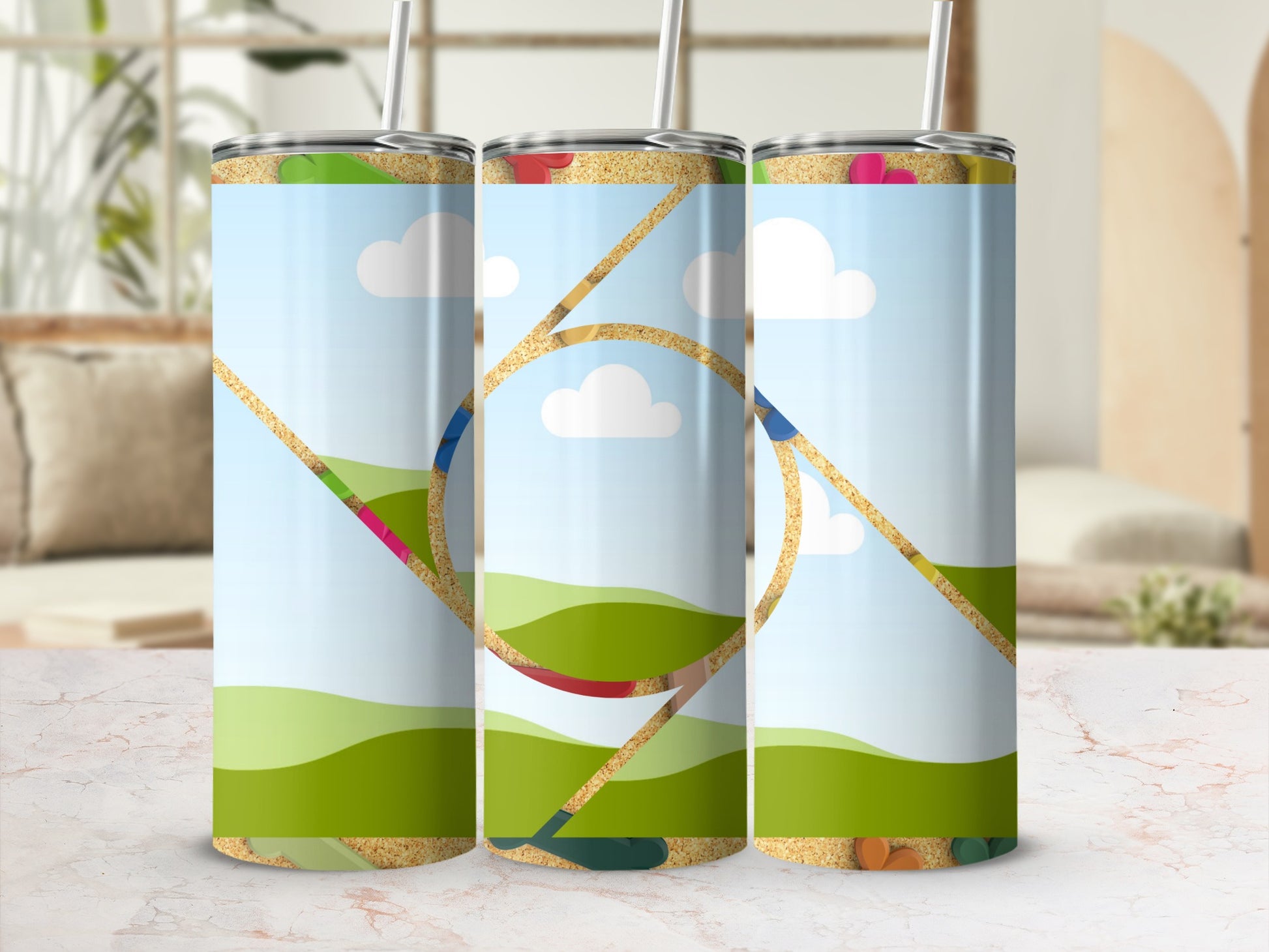 Three tumblers with a cartoon landscape, blue sky, clouds, and sand texture.