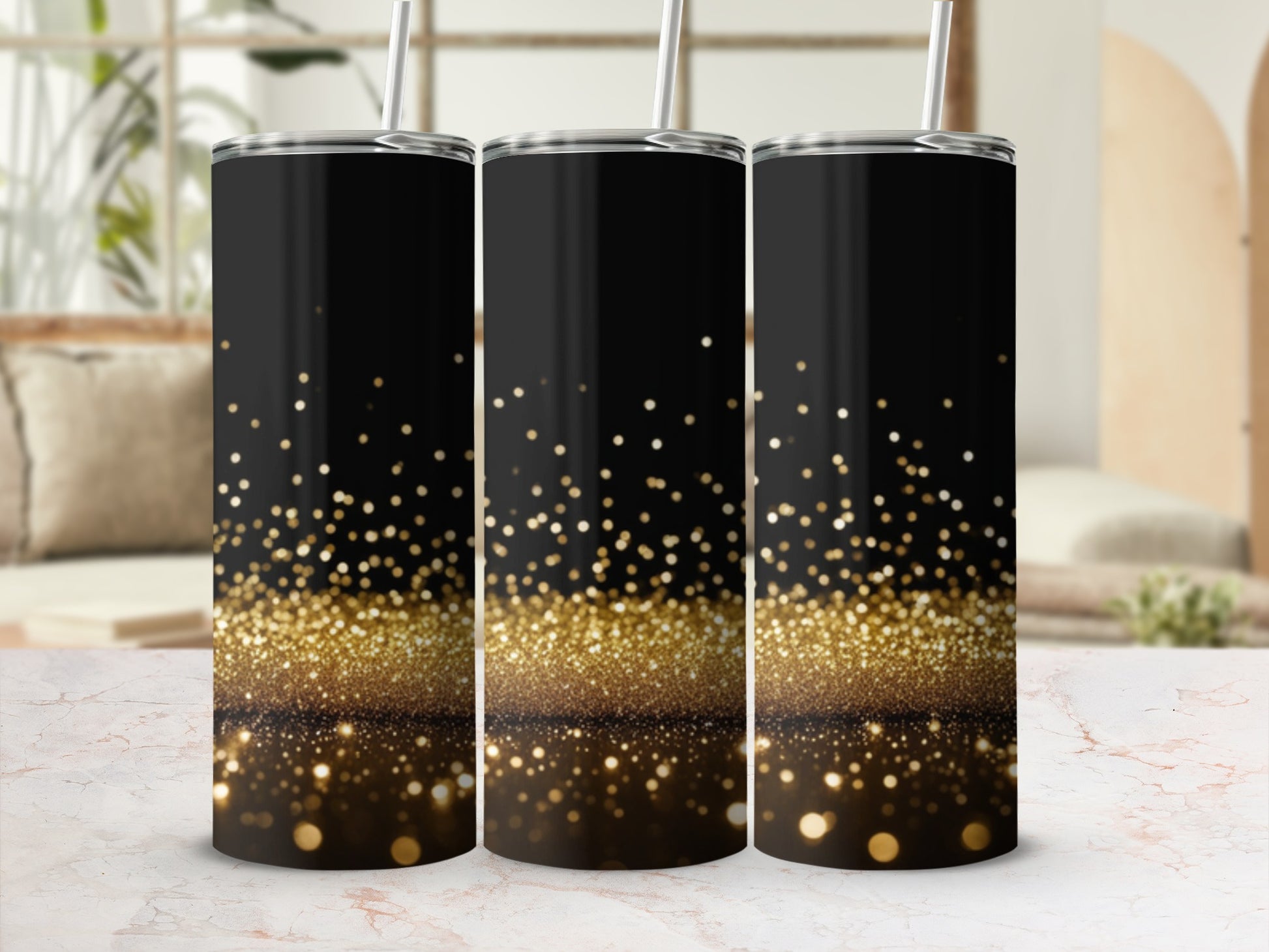 Three black tumblers with gold glitter gradient and straws.