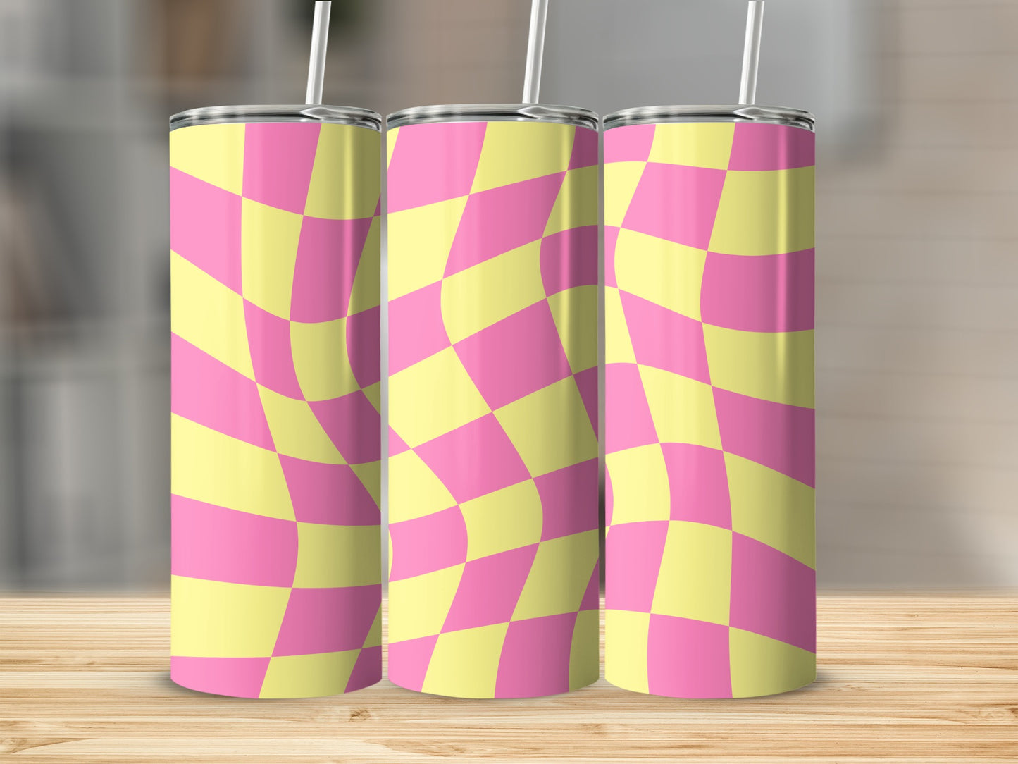 Three tumblers with a warped yellow and pink checkerboard pattern.
