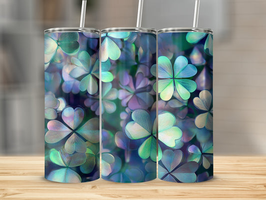 Three tumblers with a shamrock pattern on a wooden surface.