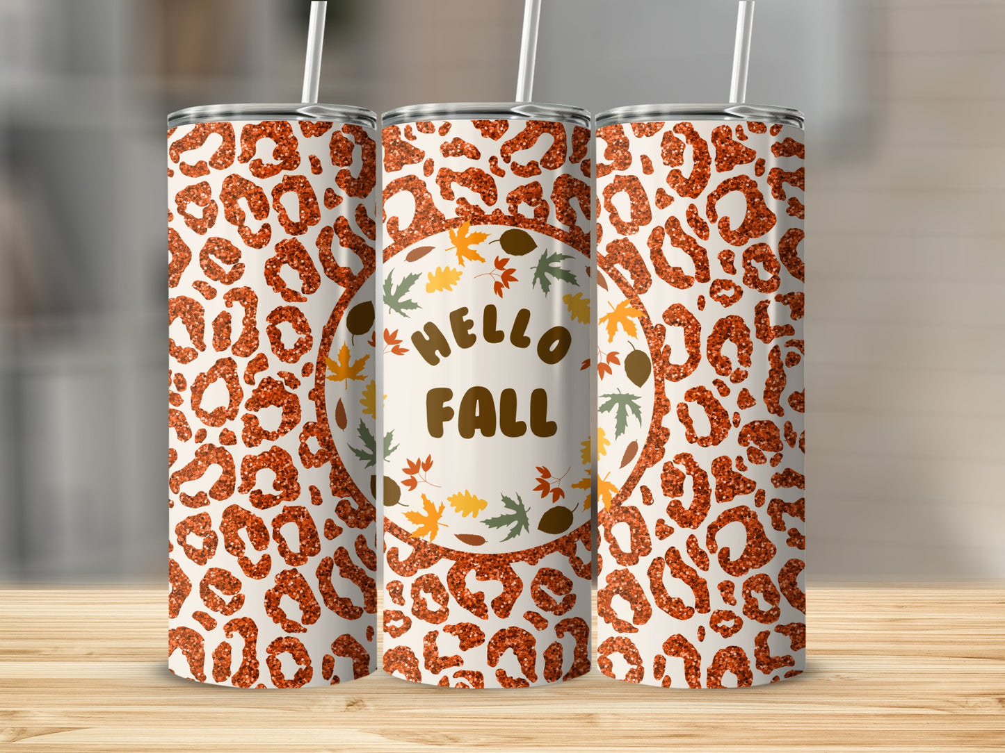 Tumbler with leopard print and "Hello Fall" text with autumn leaves.