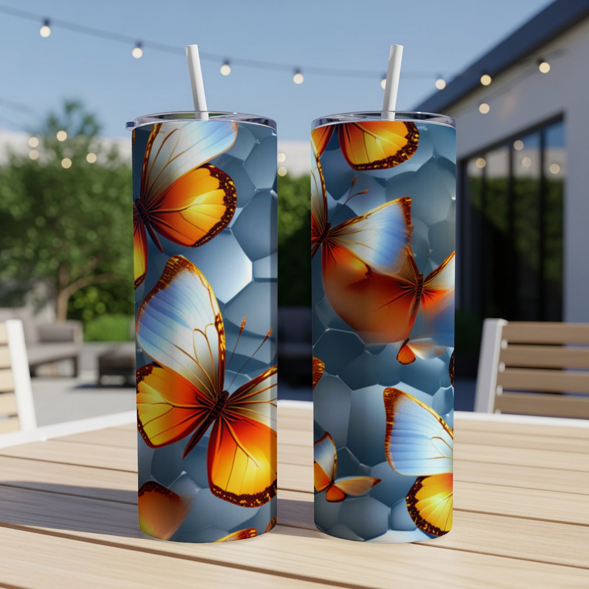 Two stainless steel tumblers with orange and blue butterfly designs.