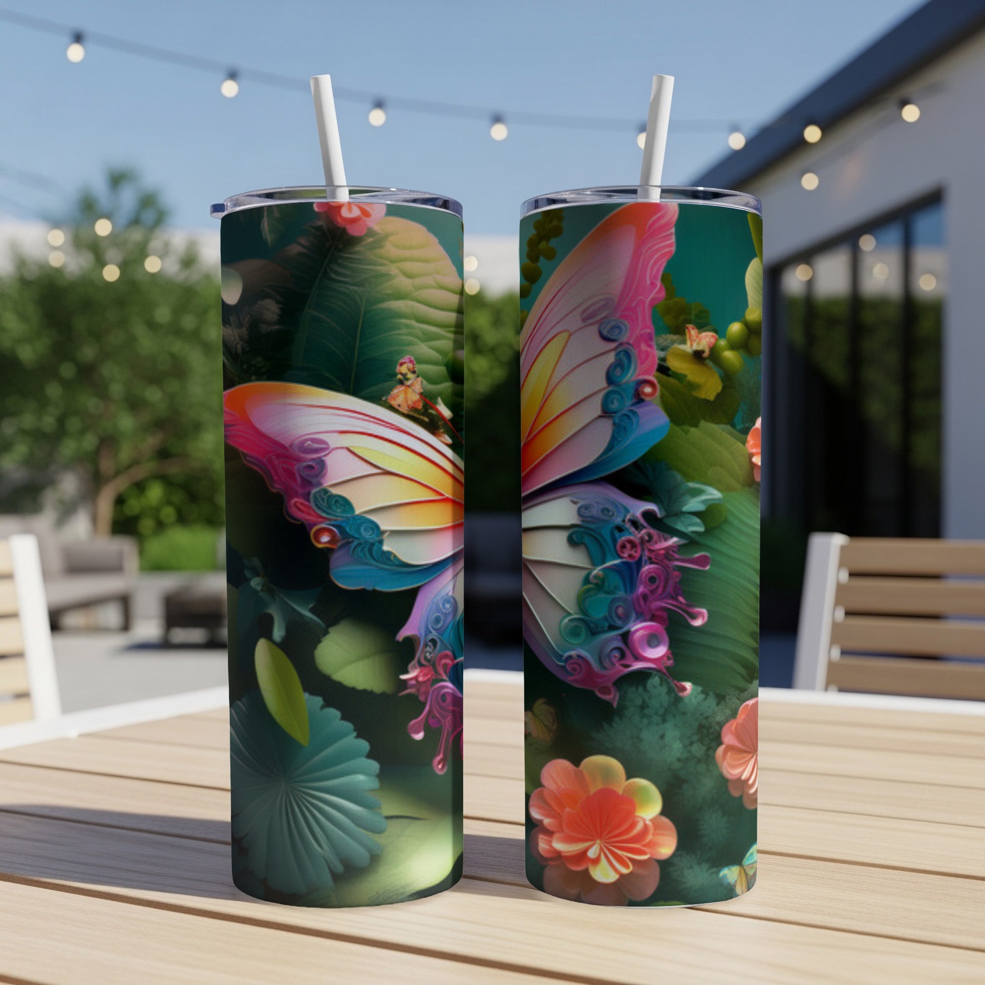 Two tumblers with a colorful butterfly and floral design on a wooden table.